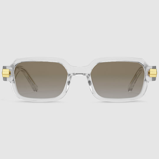 Luxora Midnight Unisex-Brille von Priolet – rechteckiger Rahmen in transparentem Design mit goldfarbenen Metallelementen und braunen, photochromen Verlaufsgläsern.